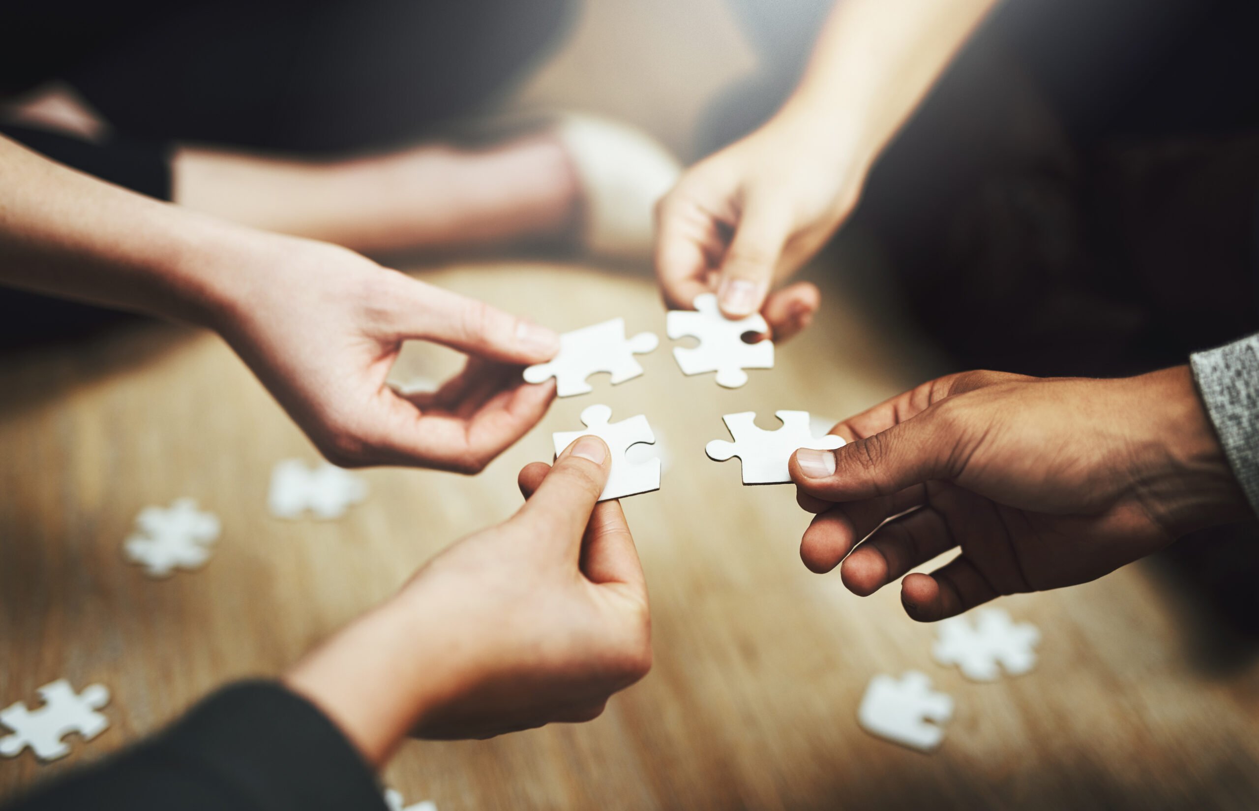 People holding jigsaw pieces