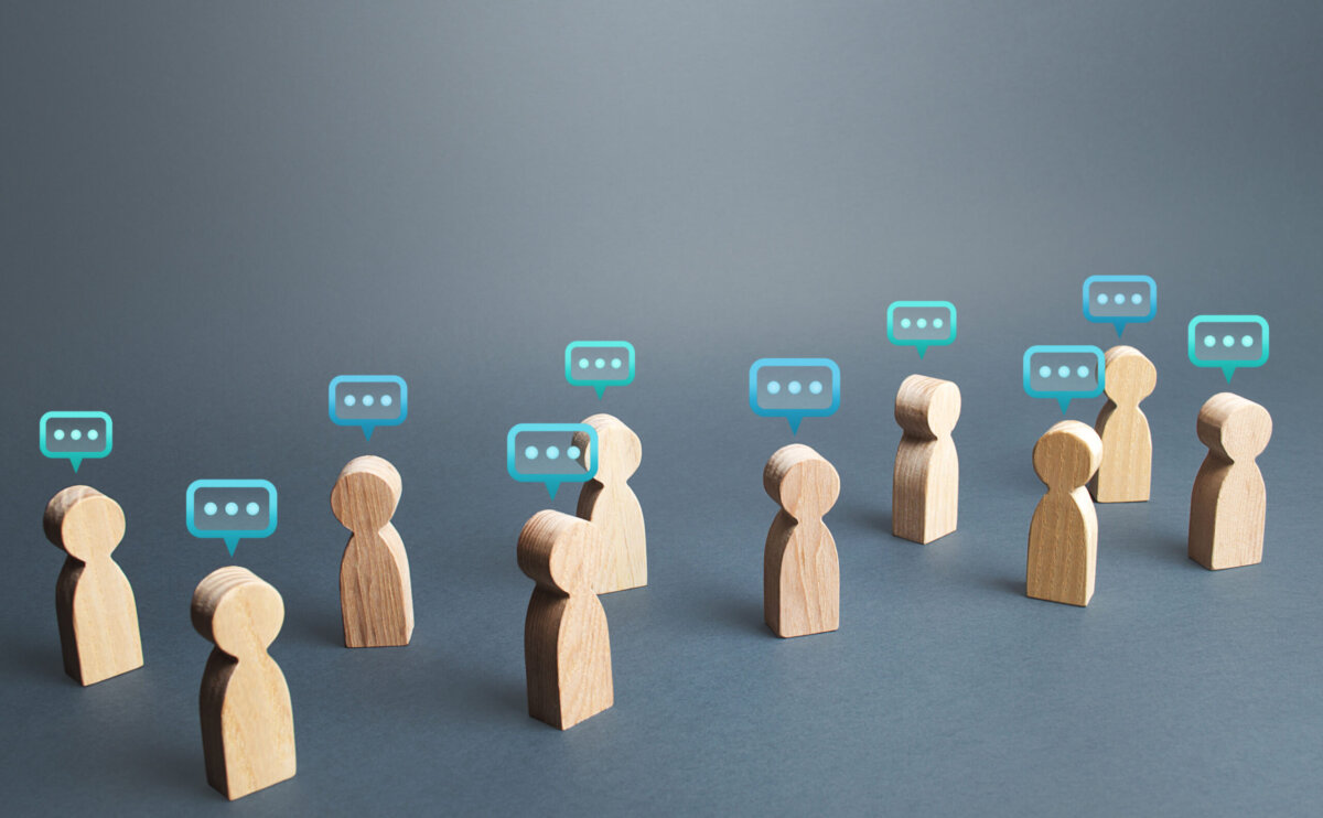 small wooden people with speech bubbles